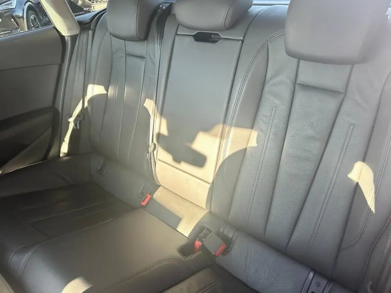 Vue intérieure des sièges arrière en cuir noir de l'Audi A5 Sportback 2018 avec appuie-têtes et ceintures visibles.