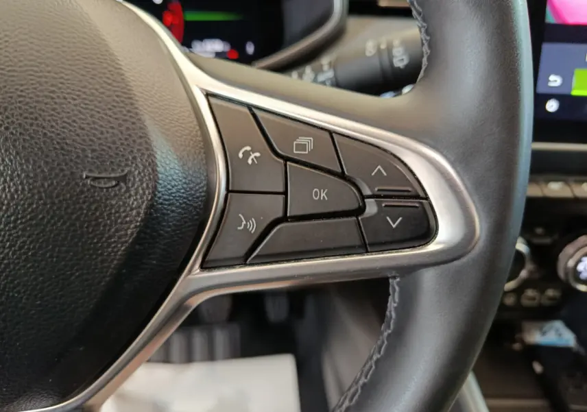 Gros plan sur les commandes multifonctions à droite du volant cuir noir de la Renault Clio Techno TCe 90 2024.
