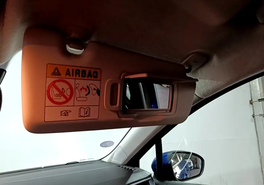 Détail du pare-soleil côté conducteur avec miroir intégré, intérieur noir et reflet bleu de la Renault Clio Business.