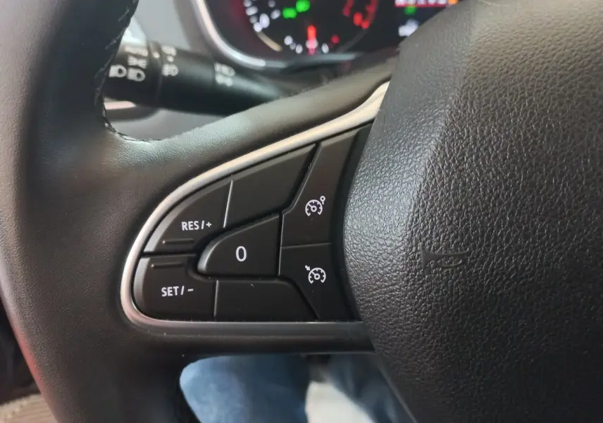 Gros plan sur les commandes du volant multifonctions noir de la Renault Mégane Business TCe 115 FAP 2022.