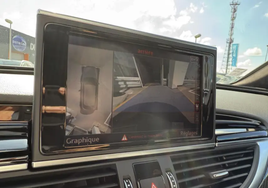 Écran central intérieur de l'Audi RS6 Avant 2016 montrant la caméra 360° avec vue arrière et dessus du véhicule.
