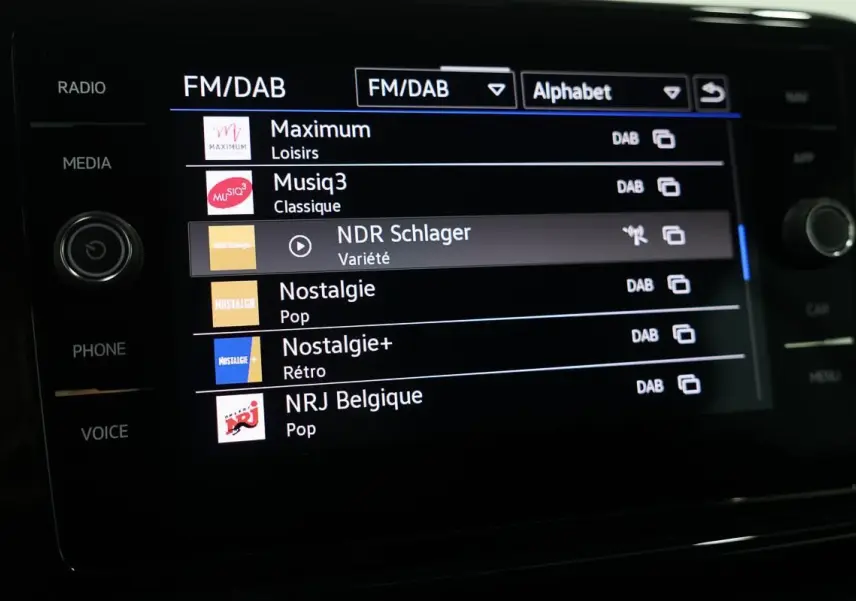 Écran tactile multimédia du Volkswagen T-Roc Cabriolet affichant les stations FM/DAB en intérieur.