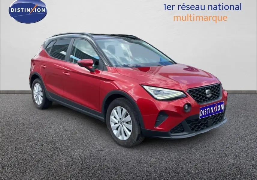 SEAT Arona rouge désir métal avec toit noir, vue 3/4 avant droit, mettant en valeur ses optiques LED et calandre noire.