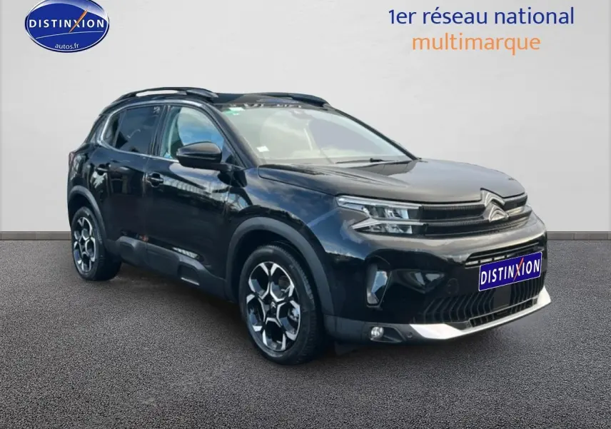 SUV Citroën C5 Aircross noir en 3/4 avant droit avec jantes alu et barres de toit visibles.