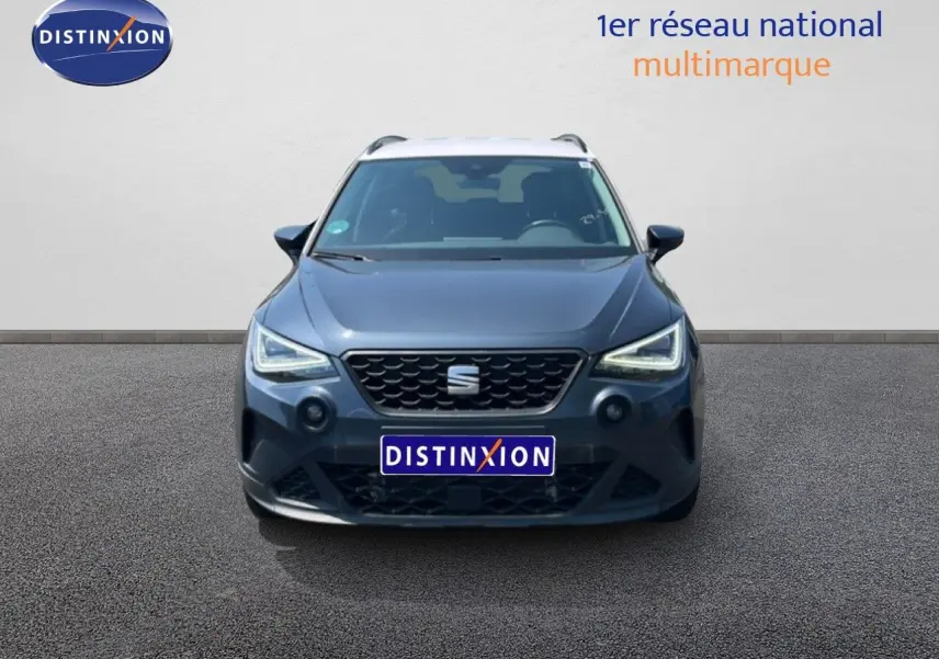 Vue avant d'un SEAT Arona gris Magnetic Metal avec toit blanc, mettant en valeur sa calandre et ses phares LED.
