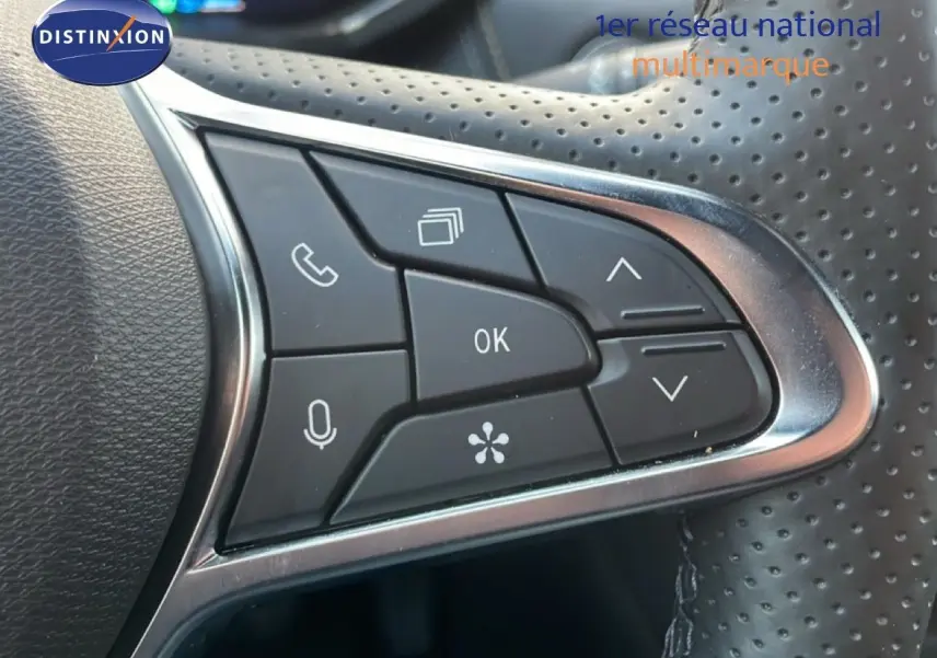 Détail des commandes multifonctions sur le volant perforé noir du Renault Symbioz gris cassiopée métal.