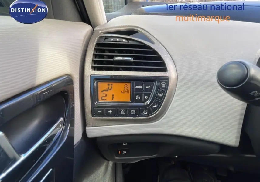 Détail du tableau de bord côté gauche avec commandes de climatisation digitale sur Citroën C4 Picasso noir métal 2008.