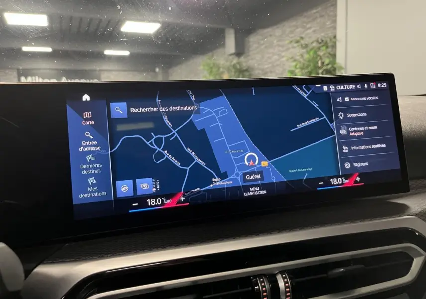 Écran central BMW Live Cockpit Navigation Pro affichant une carte avec menu climatisation, intérieur noir du véhicule.