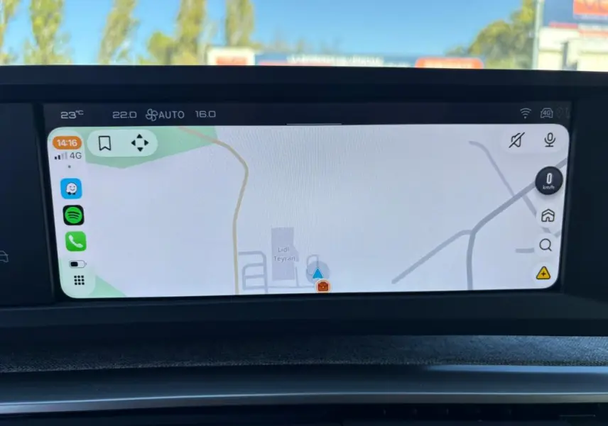 Écran tactile central affichant la navigation dans un Peugeot 5008 bleu foncé, vue intérieure frontale.