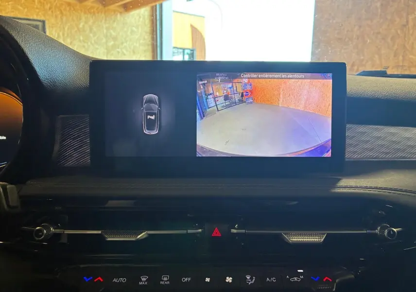 Écran central de l'Alfa Romeo Tonale 2022 affichant la caméra de recul et l'aide au stationnement, intérieur noir.