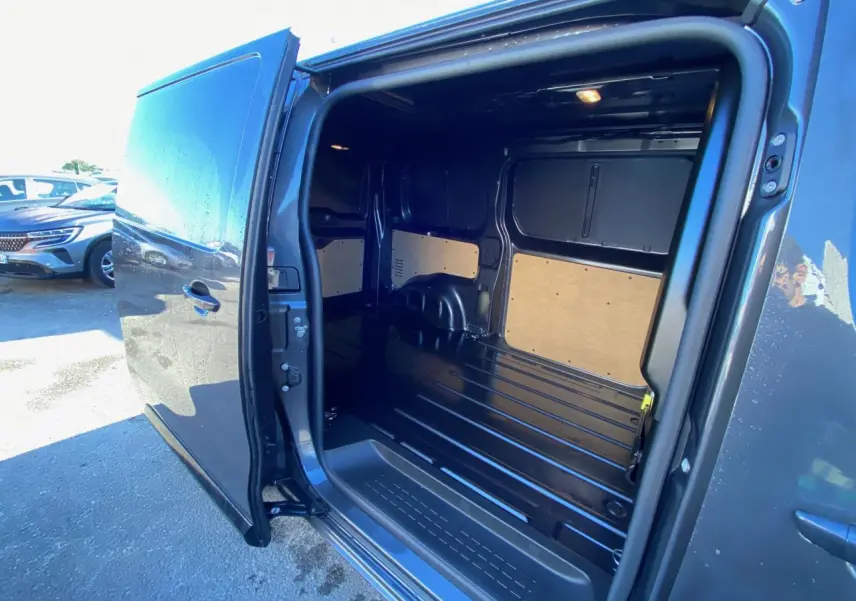 Vue latérale gauche du Peugeot Expert Fourgon gris titane avec porte coulissante ouverte montrant l'espace de chargement vide.