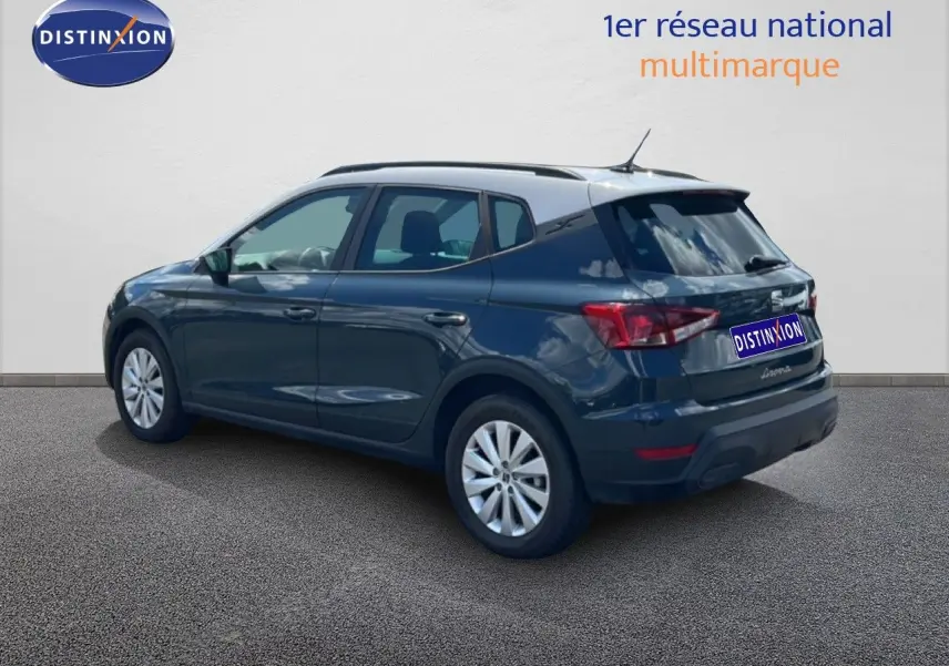 SEAT Arona bleu Fjord avec toit blanc, vue 3/4 arrière droit, mettant en valeur ses lignes compactes et ses jantes.