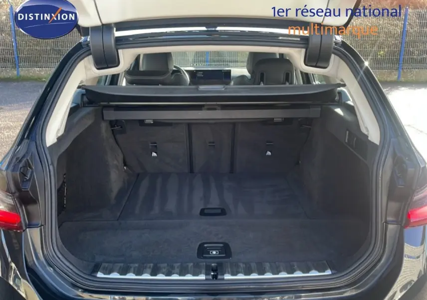 Coffre ouvert vu de l'arrière d'une BMW Série 3 Touring F31 noire, montrant un espace de chargement spacieux et propre.