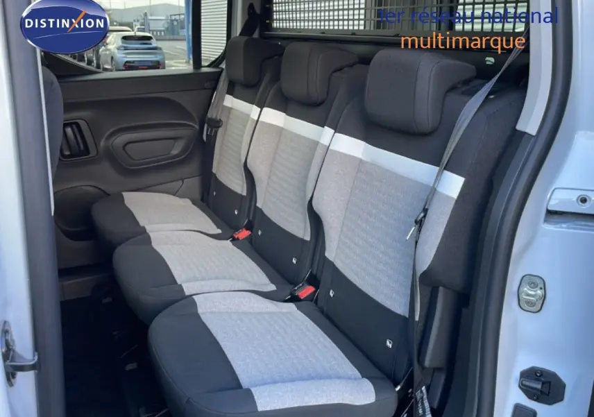 Vue intérieure côté droit montrant la banquette arrière en tissu bicolore gris et noir du Citroën Berlingo blanc glacier.