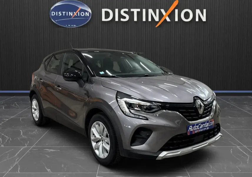 Renault Captur TCe 90 Business gris foncé toit noir, vue 3/4 avant mettant en valeur ses optiques LED et calandre distinctive.