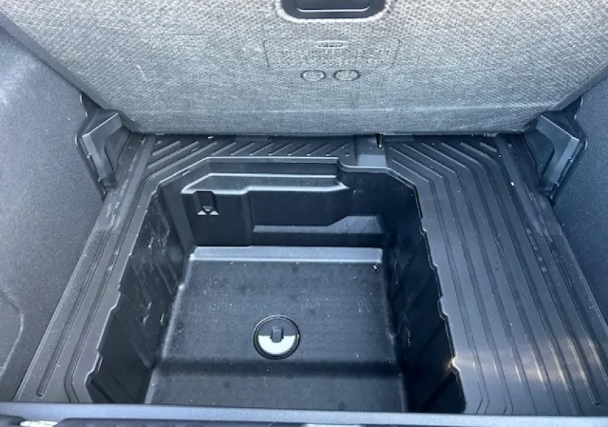 Vue plongeante sur le coffre noir agate du Ford Puma 2023, montrant le rangement sous plancher vide.