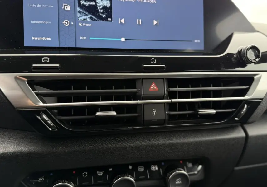 Vue rapprochée du tableau de bord de la Citroën C4 2024, montrant la console centrale noire avec écran tactile et commandes climatisation.