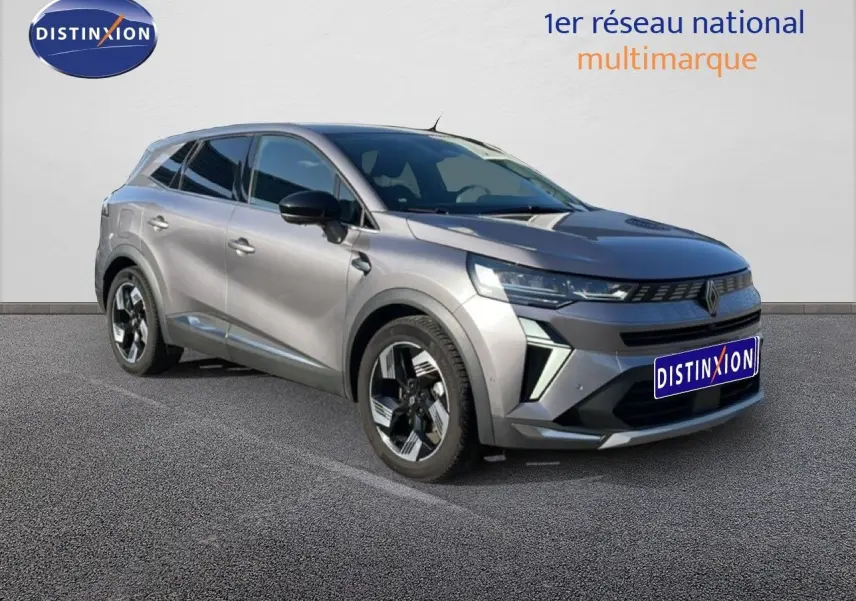 Renault Symbioz gris cassiopée métal, vue 3/4 avant droit, avec jantes bicolores et calandre moderne.