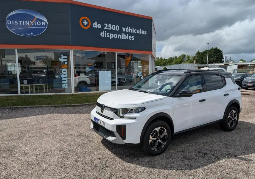 Citroën C3 Aircross blanc Banquise vue 3/4 avant droit avec toit noir Perla Nera sur parking extérieur.