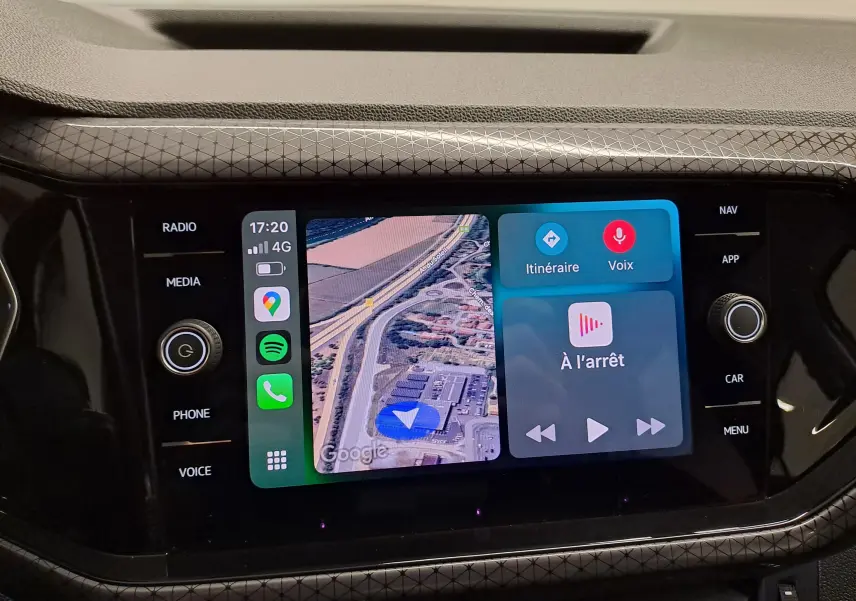 Écran tactile central du Volkswagen T-Cross 2022 affichant la navigation et les commandes vocales, entouré de boutons noirs.