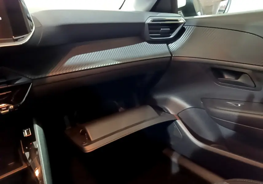 Vue intérieure côté passager de la Peugeot 208 1.5 BlueHDi 100 S&S Premium 2021, tableau de bord noir avec finition texturée.