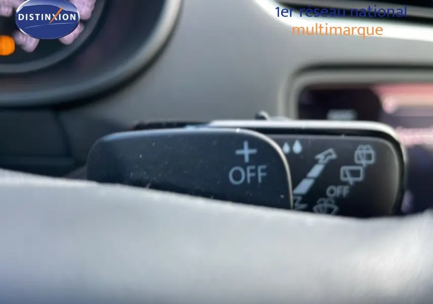 Gros plan sur la commande de régulateur de vitesse au volant d'une Skoda Octavia Combi bleu Racing Metal, intérieur gris.