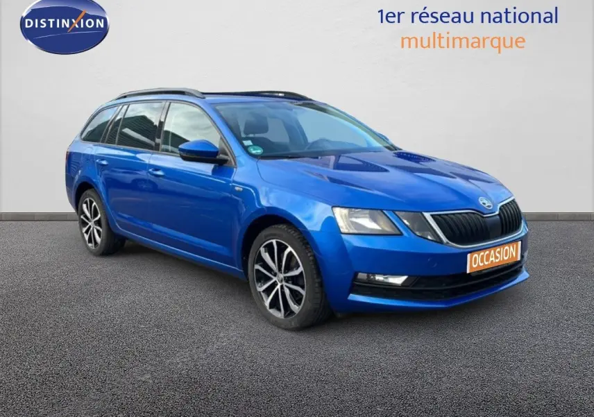 Vue 3/4 avant gauche d'une Skoda Octavia Combi bleu racing metal avec jantes alliage et toit ouvrant visible.
