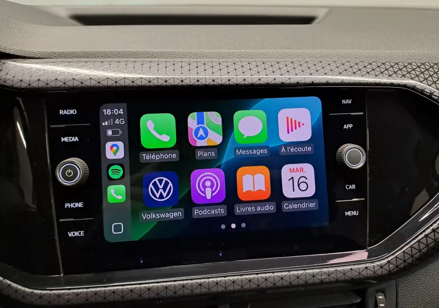 Écran tactile central du Volkswagen T-Cross 2022 affichant les applications connectées, entouré d'une finition noire texturée.