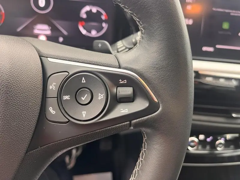 Gros plan sur les commandes audio au volant cuir noir de l'Opel Grandland 1.5 D 130ch Elegance Business 2022.