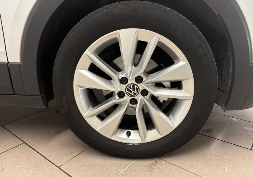 Gros plan sur la roue avant droite avec jante alliage argentée du Volkswagen T-Cross reflet d'argent 2024.