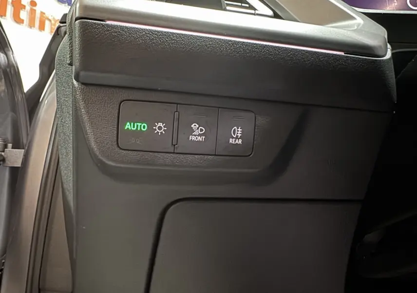 Gros plan sur les commandes d’éclairage intérieures noires du côté gauche d’un Audi Q4 E-TRON gris foncé 2022.