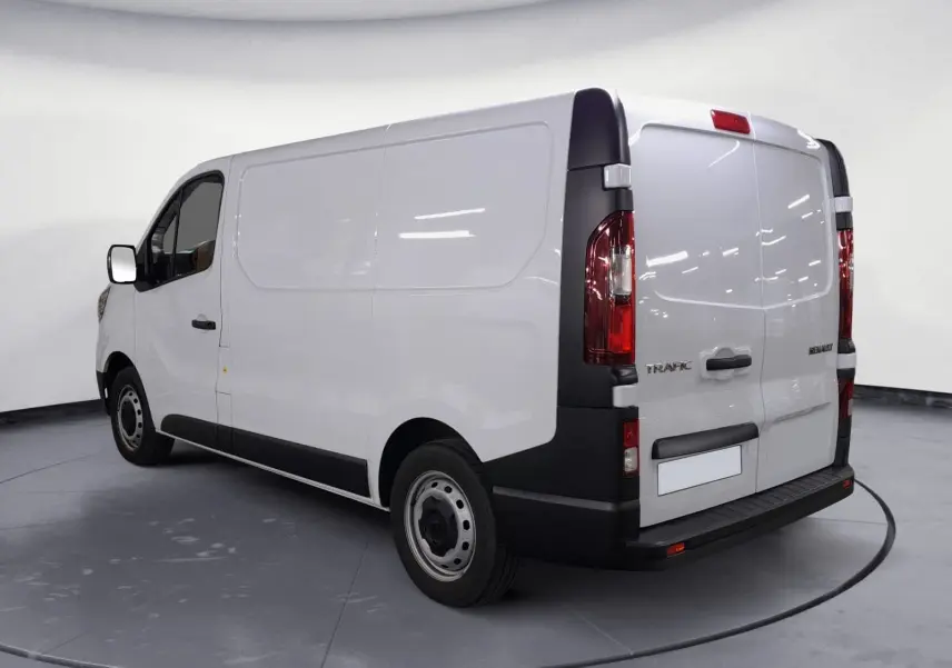 Vue 3/4 arrière droite d’un Renault Trafic Fourgon blanc 2024 avec portes arrière fermées et jantes acier.