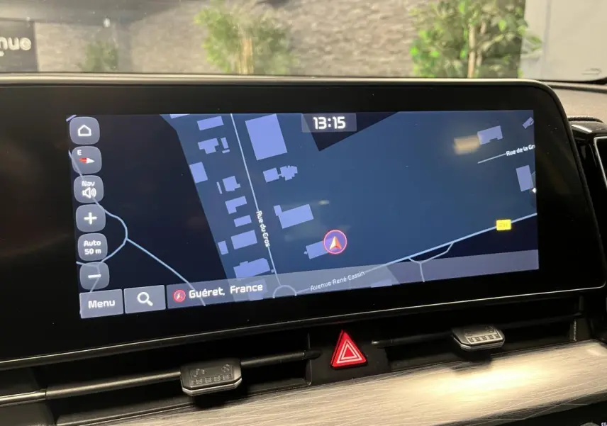 Écran tactile 12,3" du Kia Sportage 2022 affichant la navigation GPS sur fond sombre, vue intérieure avant.