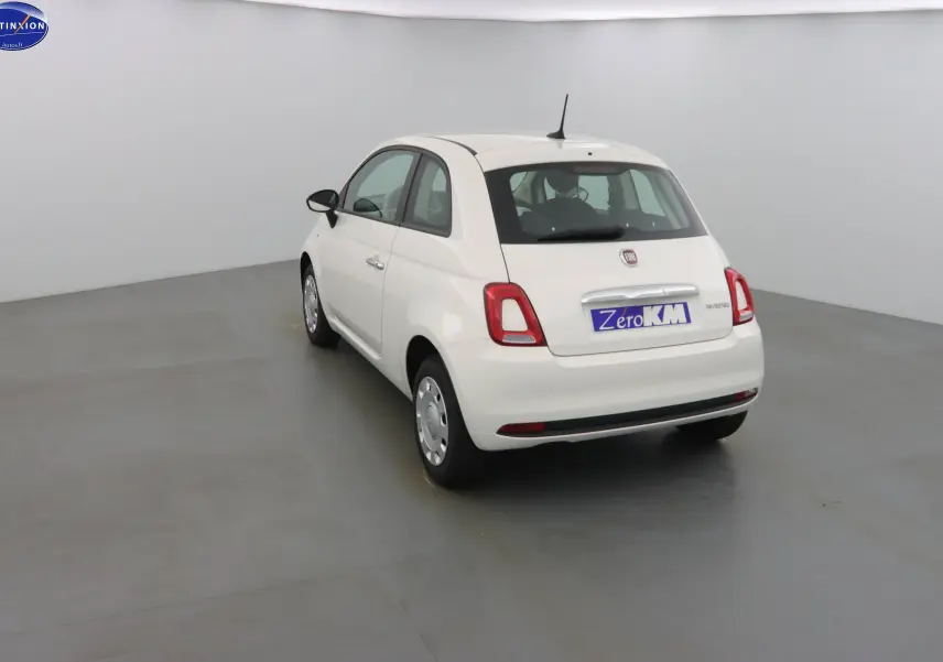 Fiat 500 blanc gelato vue 3/4 arrière gauche dans un studio, avec plaque "Zero KM" visible.