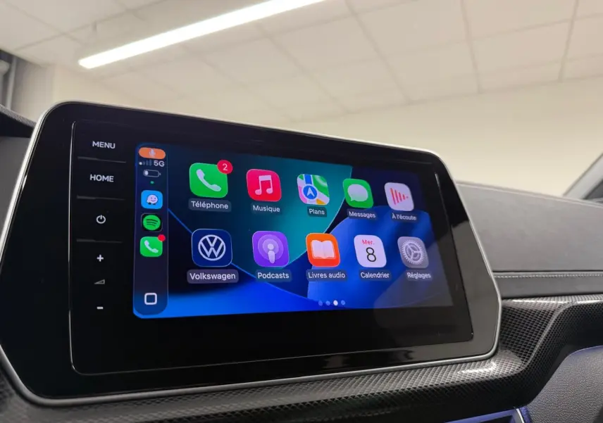Écran tactile central affichant l'interface Apple CarPlay dans l'habitacle du Volkswagen T-Cross 2024 couleur Reflet d'Argent.