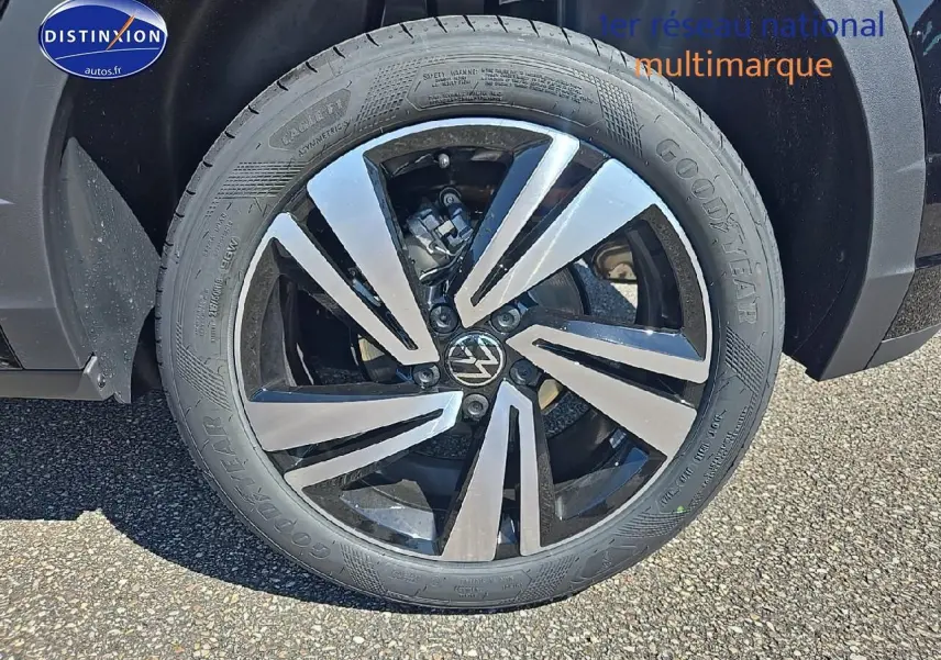 Gros plan sur la jante alliage 18 pouces Nevada noir du côté avant droit du Volkswagen T-Roc noir perle.