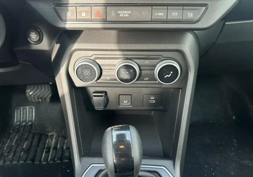 Vue rapprochée de la console centrale du Dacia Jogger kaki, avec commandes climatisation et levier de boîte automatique.
