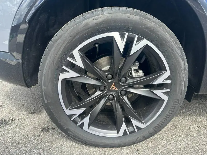 Gros plan sur la roue avant droite du CUPRA Formentor 2.0 TDI 150ch en Gris Graphène avec jante noire et argentée au design anguleux.