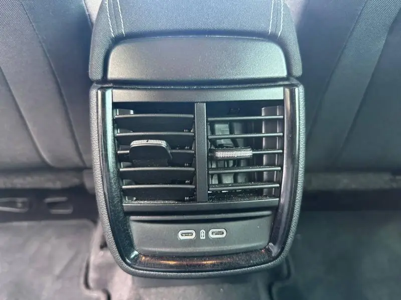 Vue rapprochée des aérateurs arrière noirs et des ports USB-C sur la console centrale d'une Skoda Scala gris graphite.