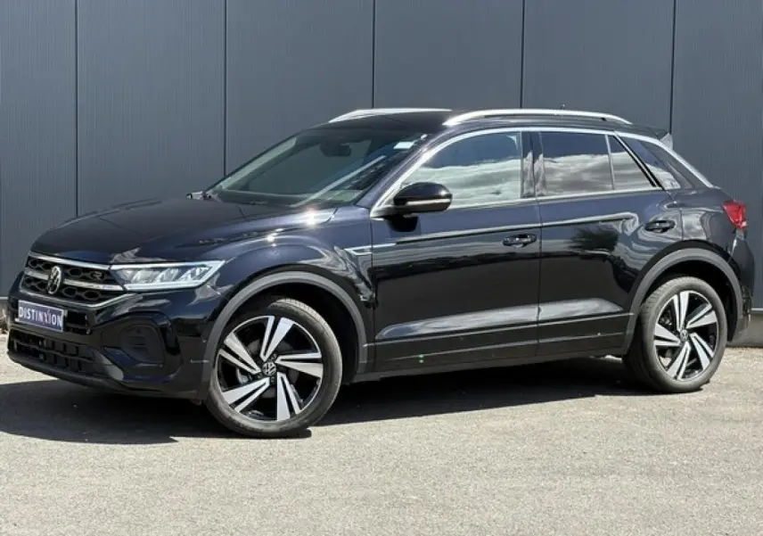 Volkswagen T-Roc noir intense en vue de profil côté gauche, avec jantes alliage 18" Nevada et détails R-Line visibles.