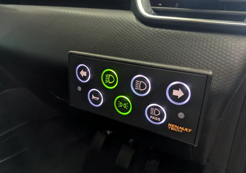 Gros plan sur le tableau de bord de la Renault Clio V gris platine, avec panneau de commandes lumineuses Renault Tech.