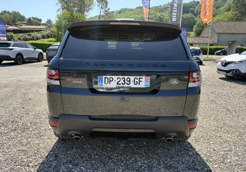Vue arrière d'un Range Rover Sport noir 2015 avec plaques françaises, feux arrière LED et double sortie d'échappement visible.