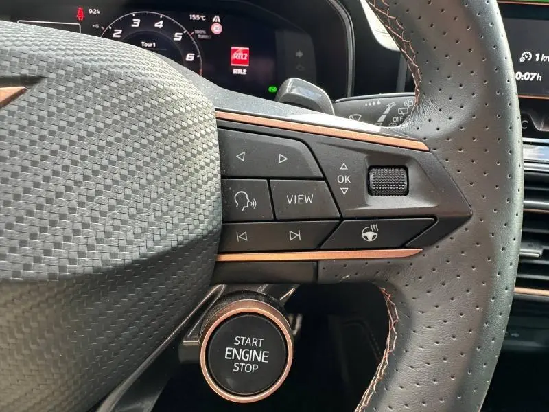 Gros plan sur le volant cuir perforé avec commandes multifonctions et bouton Start Engine Stop du CUPRA Formentor gris Magnétique.