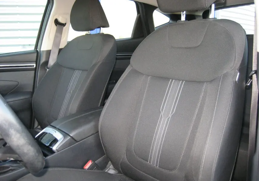 Vue rapprochée des sièges avant noirs du Hyundai Tucson 2022, mettant en valeur leur tissu et coutures centrales.