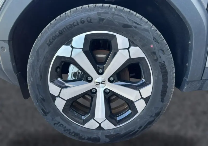 Gros plan sur la jante alu noire et argentée du Dacia Bigster gris schiste, mettant en valeur le design moderne du pneu EcoContact 6 Q.