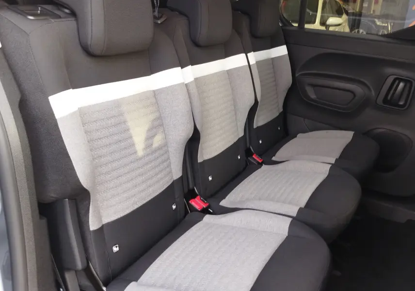 Vue latérale intérieure des sièges arrière gris clair et noir du Citroën Berlingo 2025, version 5 places.