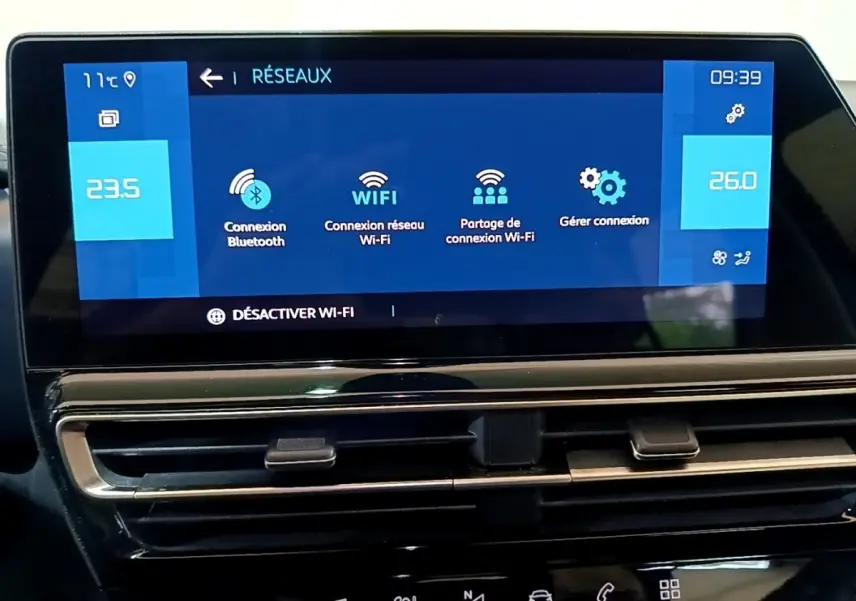 Écran tactile central du tableau de bord du Citroën C5 Aircross hybride noir, affichant les options Wi-Fi et Bluetooth.
