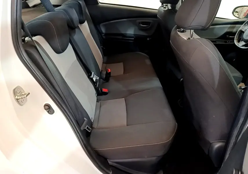 Vue intérieure côté gauche sur la banquette arrière grise et noire de la Toyota Yaris blanche 2019, version hybride.