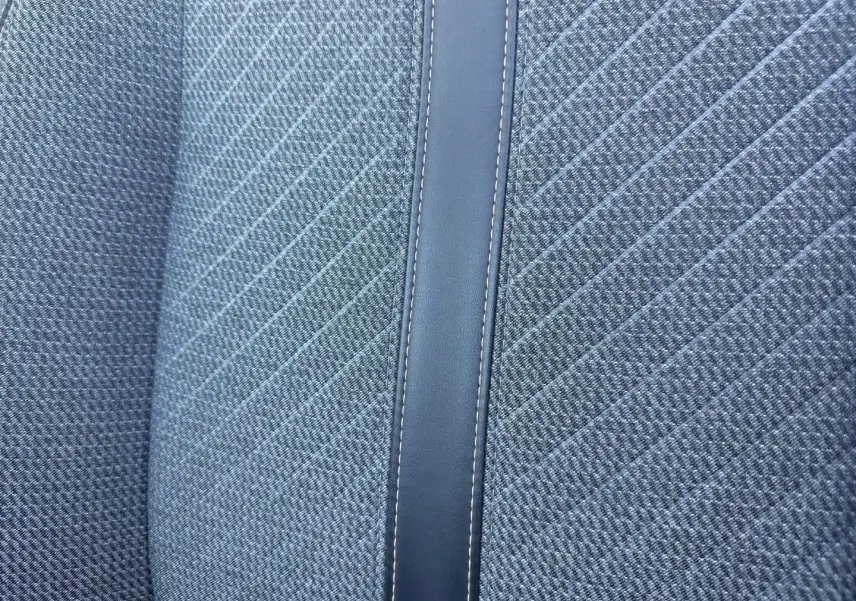 Gros plan sur le tissu gris Casual Lomsa avec bande centrale en simili cuir sur le siège avant d'une Peugeot 208 2025.