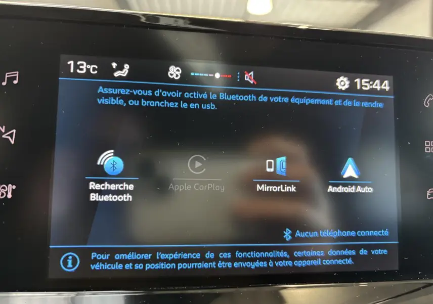 Écran tactile central de la Peugeot 208 blanc, affichant les options Bluetooth, MirrorLink et Android Auto.